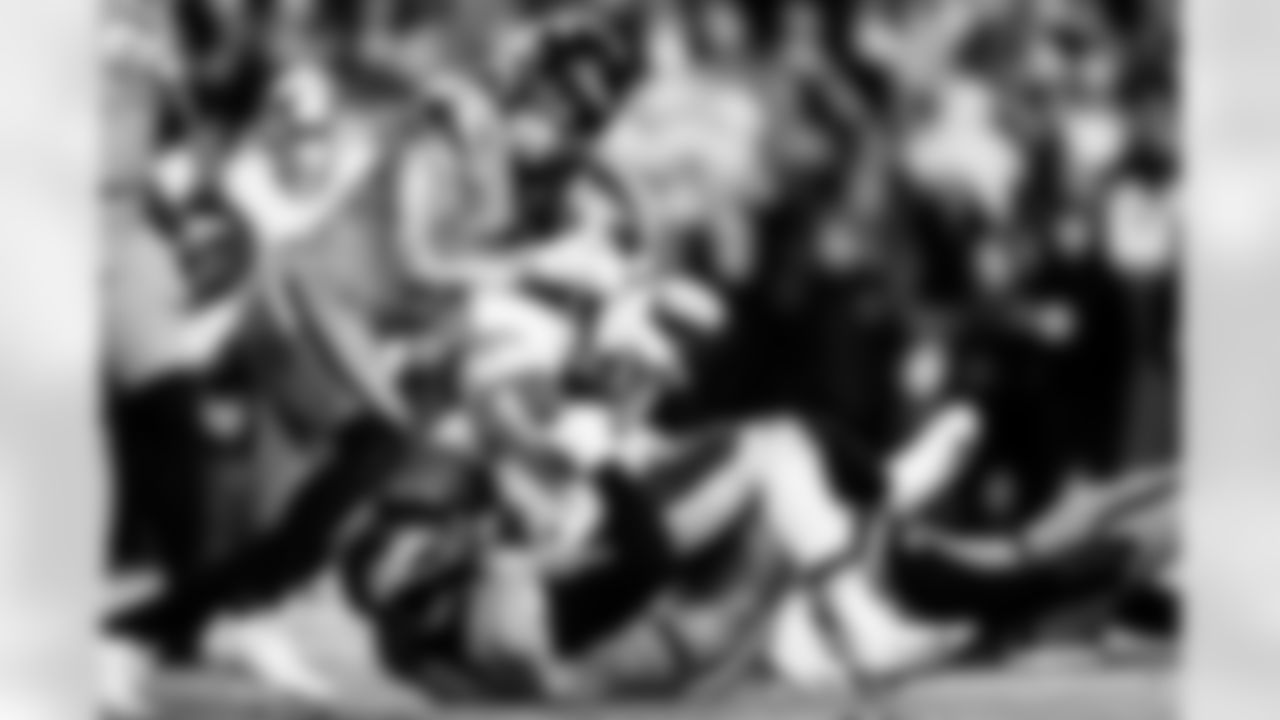 Denver Broncos safety Talanoa Hufanga (9) and linebacker Jonathon Cooper (0) tackle Washington Commanders running back Jacory Croskey-Merritt (22) during the Broncos' Week 13 game against the Washington Commanders at Northwest Stadium in Landover, Maryland on November 30, 2025. Photo by Ben Swanson / Denver Broncos