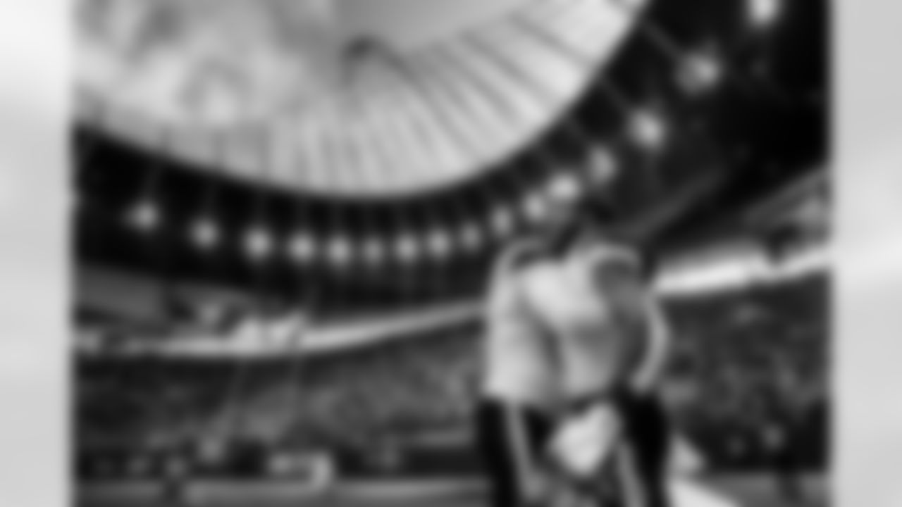 Talanoa Hufanga smiles as he hugs Jonathon Cooper and watches smoke set off above the stadium before the Broncos' Week 6 game against the New York Jets at Tottenham Hotspur Stadium in London, England on October 12, 2025. Photo by Ben Swanson / Denver Broncos