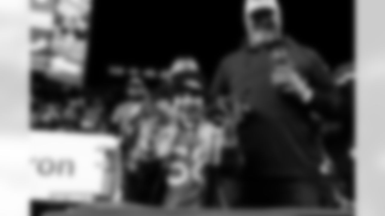 A young fan holds Denver Broncos running back J.K. Dobbins' gloves after the Broncos' Week 10 game against the Las Vegas Raiders at Empower Field at Mile High in Denver, Colorado on November 6, 2025. Photo by Gavin Liddell / Denver Broncos