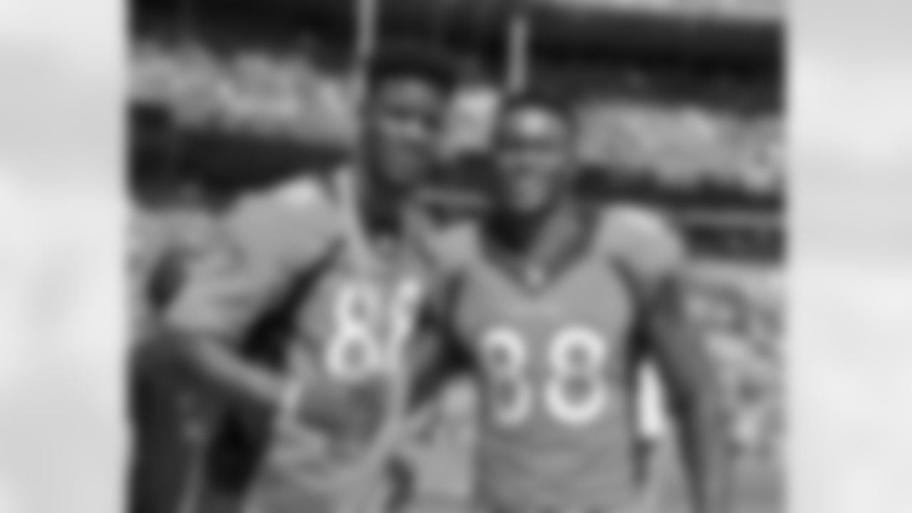 Chicago Bulls star Jimmy Butler and Demaryius Thomas greet one another during pregame warmups before the NFL game between the Denver Broncos and the Baltimore Ravens at Sports Authority Field in Denver, CO on September 13, 2015. (Photo: © Eric Lars Bakke/ Denver Broncos)