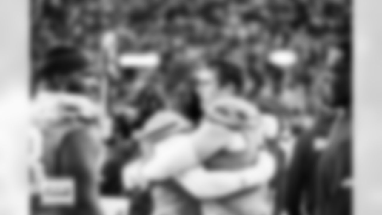 Denver Broncos linebacker Jonathon Cooper (0) hugs defensive end Zach Allen (99)  during the Broncos' Week 8 game against the Dallas Cowboys at Empower Field at Mile High in Denver, Colorado on October 26, 2025. Photo by Gabriel Christus / Denver Broncos