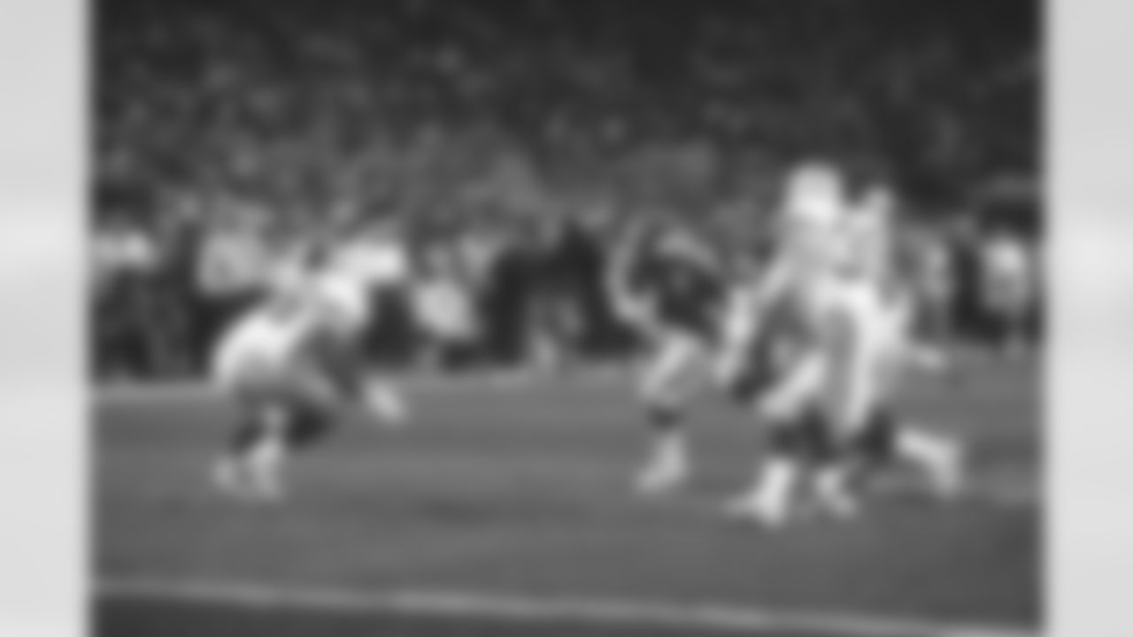 John Elway scrambles with the ball in the third quarter on a crucial third-down play and gains the first down in Super Bowl XXXII against the Packers. The diving attempt and 180-degree spin was a pivotal moment, now known as "The Helicopter, showing Elway's desire to risk everything for the win at Qualcomm Stadium in San Diego, CA on January 25, 1998.