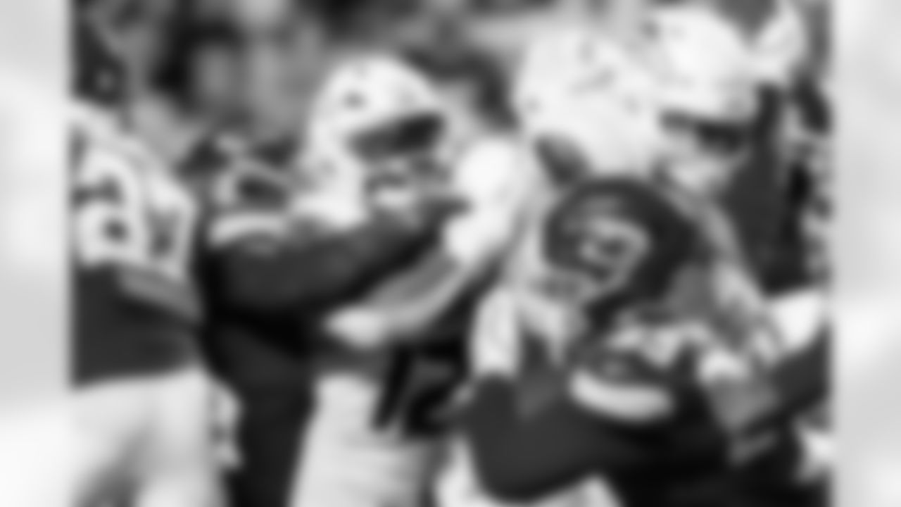 Denver Broncos running back RJ Harvey (12) runs with the ball behind a block from center Alex Forsyth (54) during the Broncos' Week 17 game against the Kansas City Chiefs at GEHA Field at Arrowhead Stadium in Kansas City, Missouri on December 25, 2025. Photo by Ben Swanson / Denver Broncos