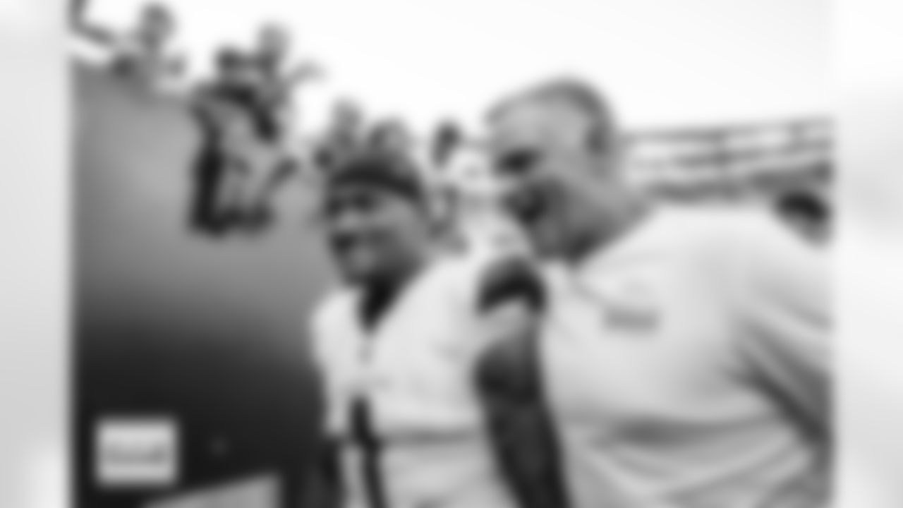 Denver Broncos tight end Evan Engram (1) and Joe Lombardi celebrate as they exit the field after the Broncos' Week 5 game against the Philadelphia Eagles at Lincoln Financial Field in Philadelphia, Pennsylvania on October 5, 2025. Photo by Ben Swanson / Denver Broncos