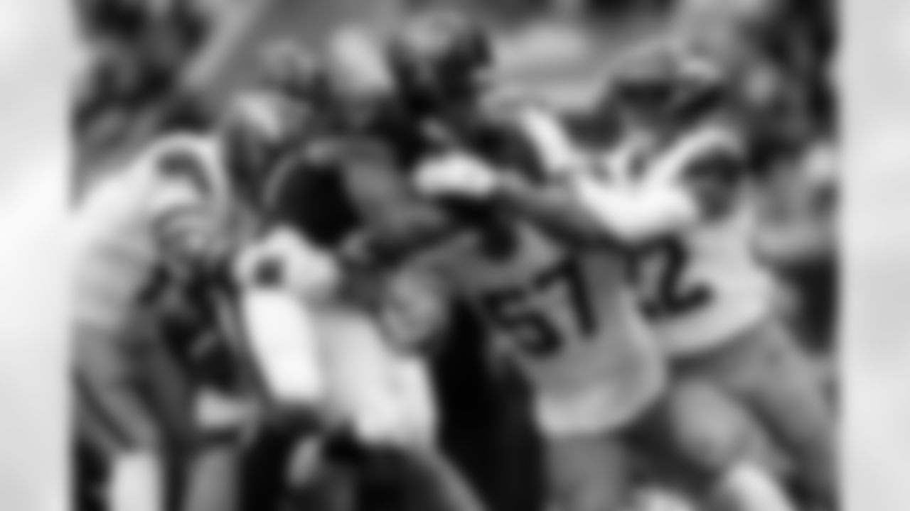 Denver Broncos linebacker Dre Greenlaw (57), defensive end Zach Allen (99) and safety Brandon Jones (22) tackle Houston Texans running back Nick Chubb (21) during the Broncos' Week 9 game against the Houston Texans at NRG Stadium in Houston, Texas on November 2, 2025. Photo by Ben Swanson / Denver Broncos