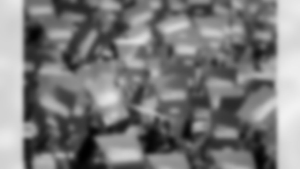 Fans hold the Vamos Broncos cards before the Broncos' Week 8 game against the Dallas Cowboys at Empower Field at Mile High in Denver, Colorado on October 26, 2025. Photo by Ben Swanson / Denver Broncos