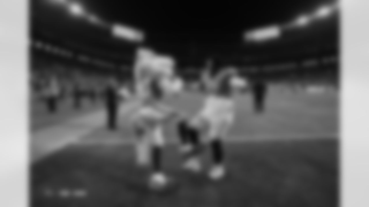 Miles the Mascot and Malcolm Roach (97) during the Broncos' Week 15 game against the Green Bay Packers at Empower Field at Mile High in Denver, Colorado on December 14, 2025. Photo by Ben Swanson / Denver Broncos