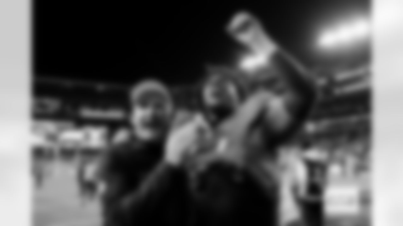 Special Teams Coordinator/Assistant Head Coach Darren Rizzi and defensive tackle Malcolm Roach (97) celebrate as the walk off the field after the Broncos' Week 13 game against the Washington Commanders at Northwest Stadium in Landover, Maryland on November 30, 2025. Photo by Ben Swanson / Denver Broncos