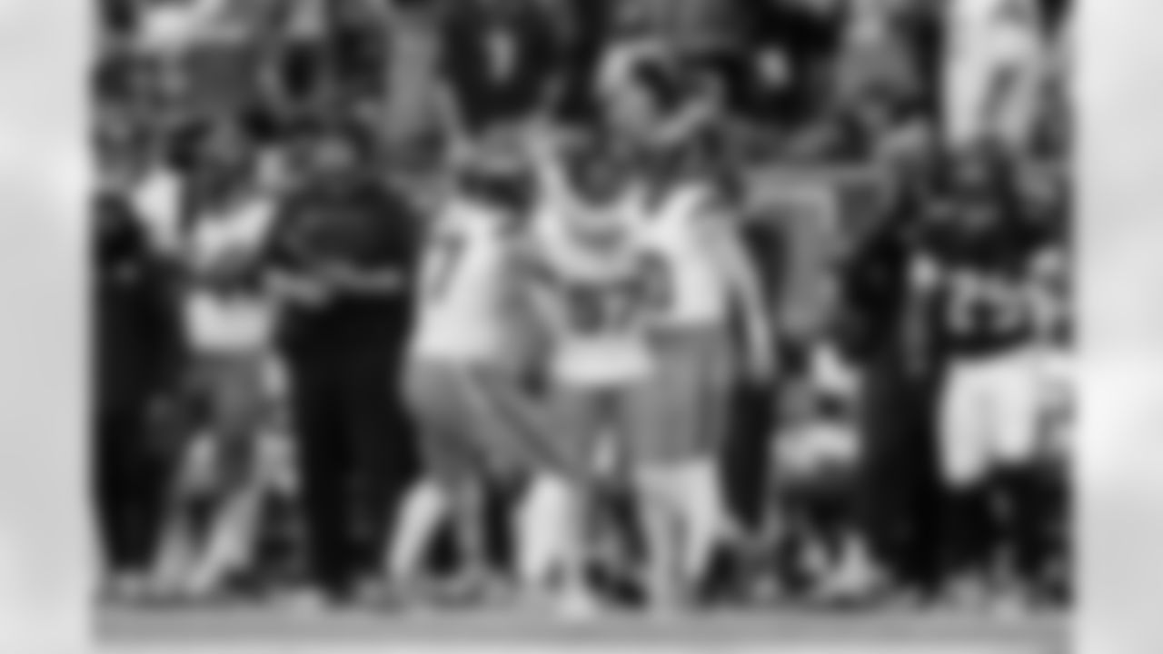 Denver Broncos guard Quinn Meinerz (77) and linebacker Dre Greenlaw (57) celebrate with quarterback Bo Nix (10) after his run during the Broncos' Week 9 game against the Houston Texans at NRG Stadium in Houston, Texas on November 2, 2025. Photo by Ben Swanson / Denver Broncos