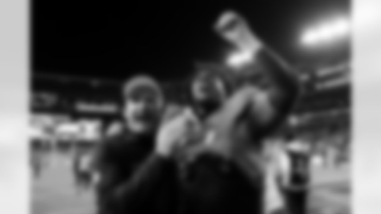 Special Teams Coordinator/Assistant Head Coach Darren Rizzi and defensive tackle Malcolm Roach (97) celebrate as the walk off the field after the Broncos' Week 13 game against the Washington Commanders at Northwest Stadium in Landover, Maryland on November 30, 2025. Photo by Ben Swanson / Denver Broncos