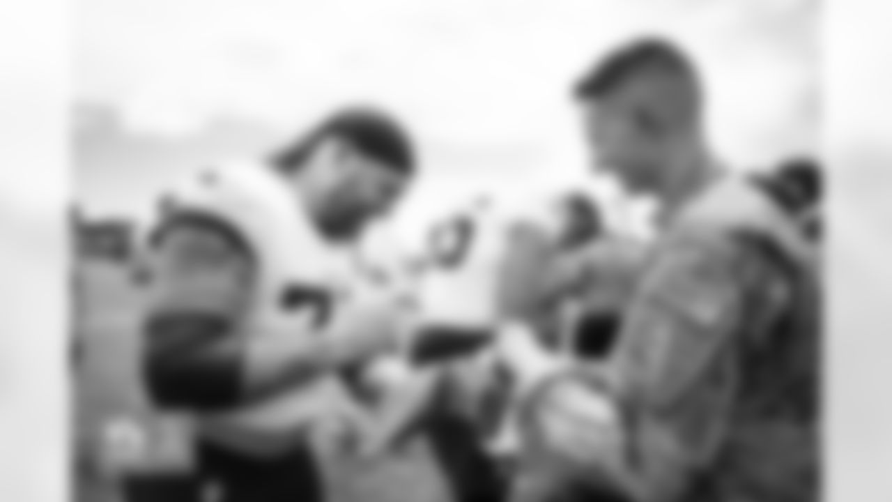 Quinn Meinerz signs autographs for military members during a visit to practice in partnership with USAA at Broncos Park Powered by CommonSpirit in Englewood, Colorado on August 21, 2024. Photo by Ben Swanson / Denver Broncos