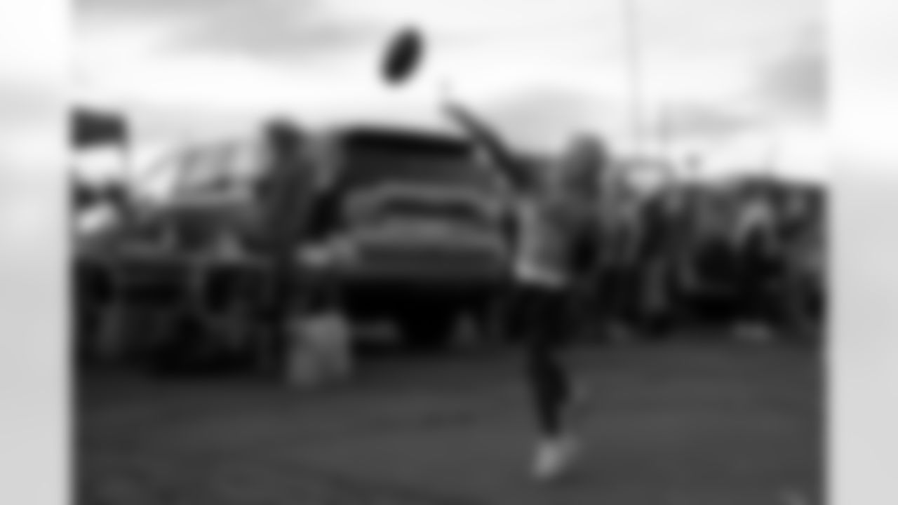 A young fan plays football in the parking lot before the Broncos' Week 11 game against the Minnesota Vikings at Empower Field at Mile High in Denver, Colorado on November 19, 2023. Photo by Rachel O'Driscoll / Denver Broncos