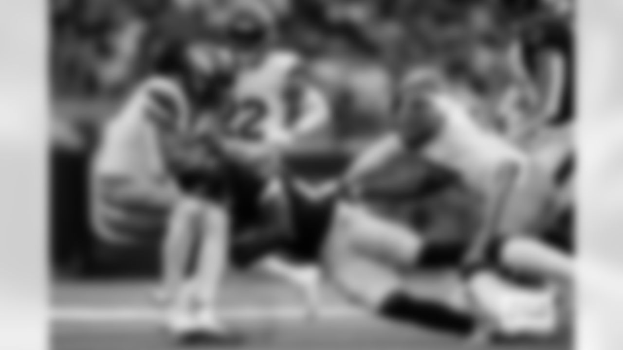 Denver Broncos safety Talanoa Hufanga (9) and linebacker Que Robinson (51) tackle Houston Texans running back Woody Marks (27) during the Broncos' Week 9 game against the Houston Texans at NRG Stadium in Houston, Texas on November 2, 2025. Photo by Gabriel Christus / Denver Broncos