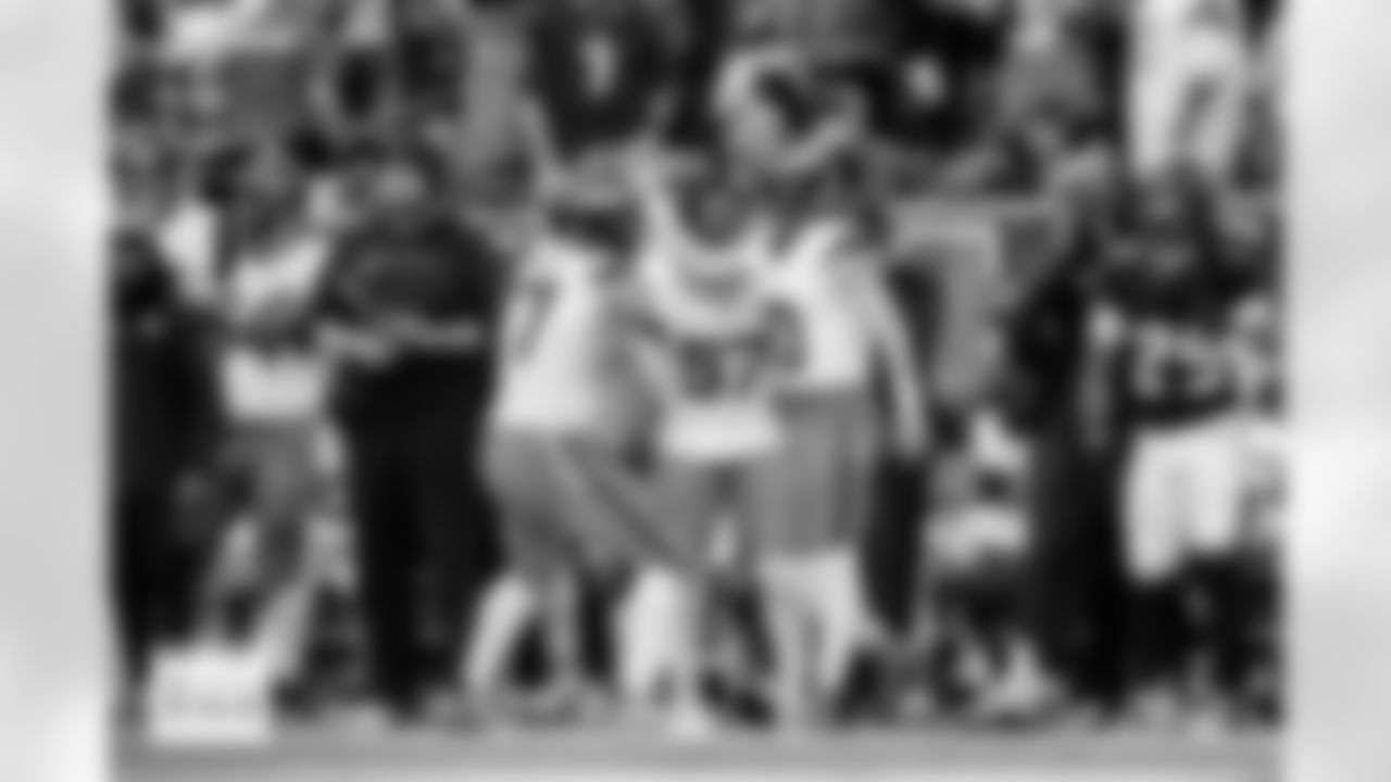 Denver Broncos guard Quinn Meinerz (77) and linebacker Dre Greenlaw (57) celebrate with quarterback Bo Nix (10) after his run during the Broncos' Week 9 game against the Houston Texans at NRG Stadium in Houston, Texas on November 2, 2025. Photo by Ben Swanson / Denver Broncos