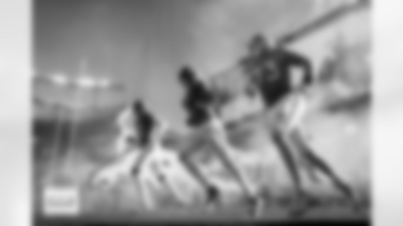 Denver Broncos linebacker Que Robinson (51), tight end Marcedes Lewis (89) and offensive tackle Frank Crum (73) run onto the field during team and player introductions before the Broncos' Week 11 game against the Kansas City Chiefs at Empower Field at Mile High in Denver, Colorado on November 16, 2025. Photo by Ben Swanson / Denver Broncos