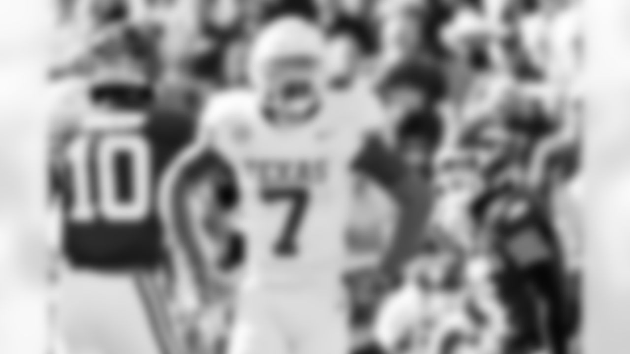 Texas defensive back Jahdae Barron (7) celebrates after making a big tackle against Arkansas during the first half of an NCAA college football game Saturday, Nov. 16, 2024, in Fayetteville, Ark. (AP Photo/Michael Woods)