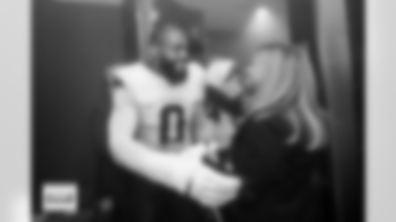 Denver Broncos linebacker Jonathon Cooper (0) celebrates with Carrie Walton Penner in the locker room after the Broncos' Week 6 game against the New York Jets at Tottenham Hotspur Stadium in London, England on October 12, 2025. Photo by Gabriel Christus / Denver Broncos