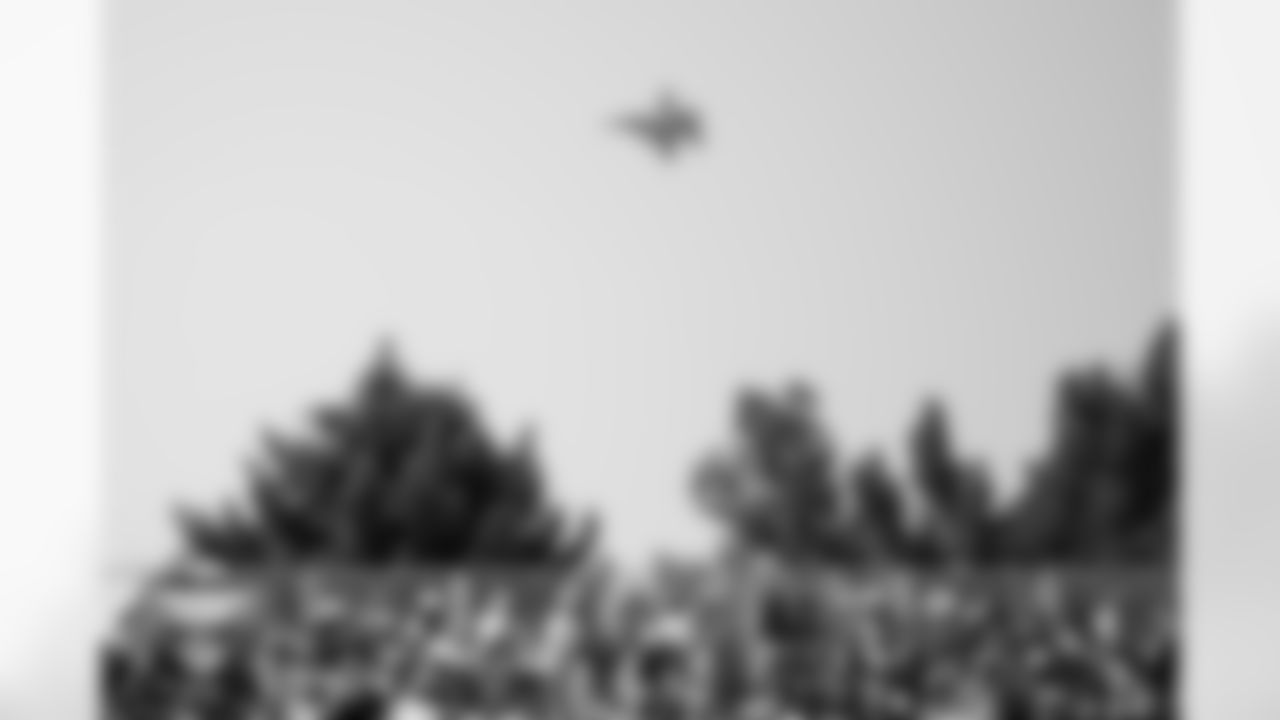 A military jet flies behind fans during a training camp practice at Broncos Park Powered by CommonSpirit on July 25, 2025 in Englewood, Colorado. Photo by Ben Swanson / Denver Broncos