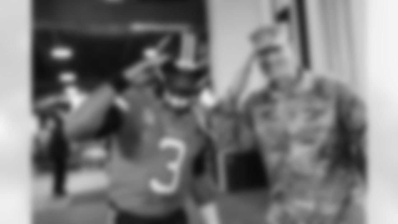 Russell Wilson and military service members in the tunnel during player and team introductions before the Broncos' Week 11 game against the Las Vegas Raiders at Empower Field at Mile High in Denver, Colorado on November 20, 2022. (Photo by Ben Swanson)