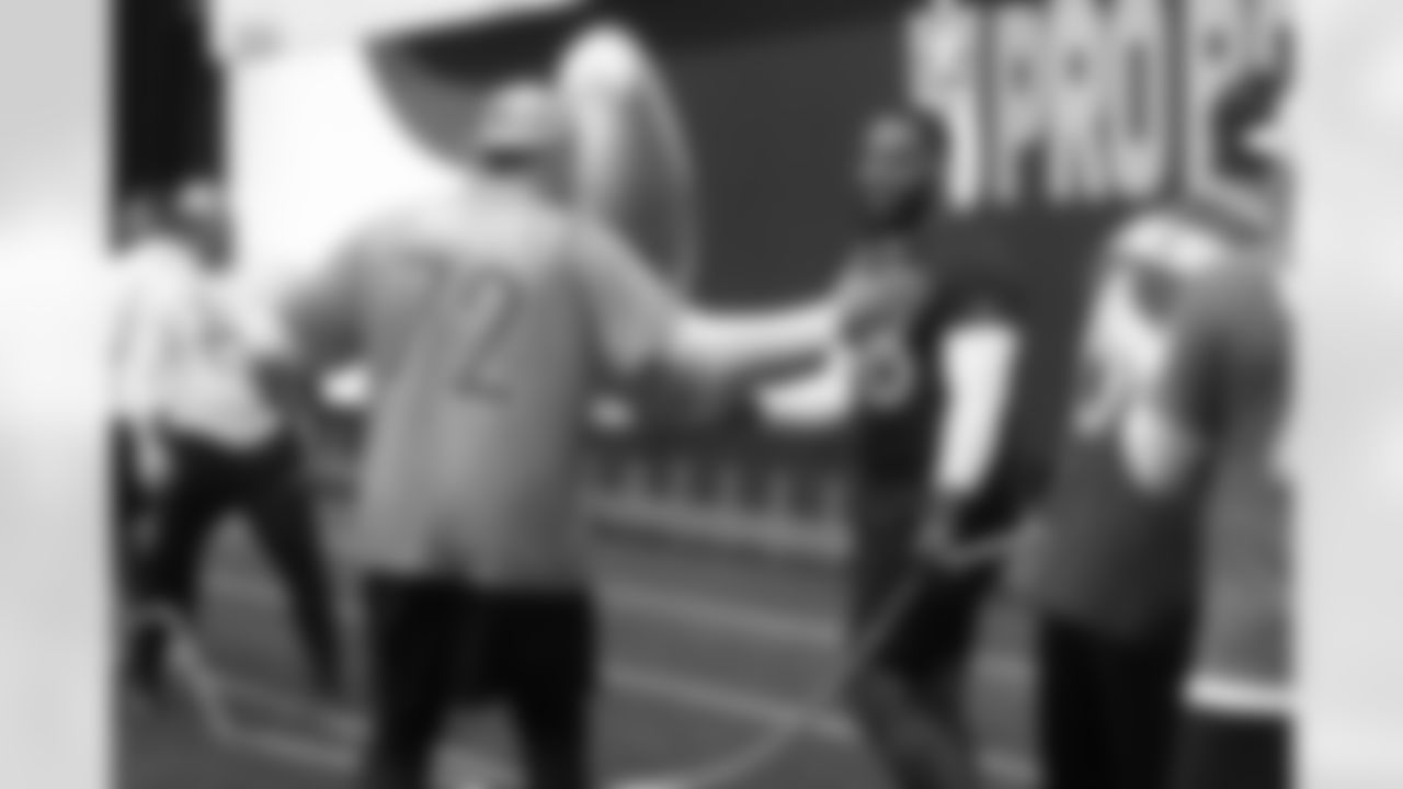 AFC offensive tackle Garett Bolles (72), of the Denver Broncos, celebrates with defensive lineman Jeffery Simmons, of the Tennessee Titans, after a tug of war against the NFC during an NFL Pro Bowl Games skills competition in San Francisco, Monday, Feb. 2, 2026. (AP Photo/Jeff Chiu)