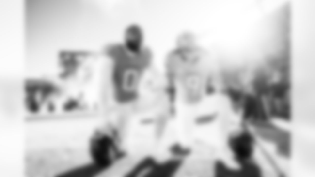 Denver Broncos linebacker Jonathon Cooper (0) and safety Talanoa Hufanga (9) kneel in prayer before the Broncos' Divisional Round playoff game against the Buffalo Bills at Empower Field at Mile High in Denver, Colorado on January 17, 2026. Photo by Ben Swanson / Denver Broncos