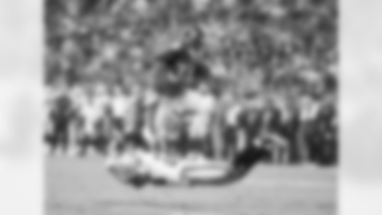 Lance Ball (35) leaps to avoid the tackle of Oakland Raider Joe Porter (28) on a 9-yard catch-and-run for a touchdown in fourth-quarter action against the Oakland Raiders in the NFL game on September 12, 2011 at Sports Authority Field at Mile High in Denver.