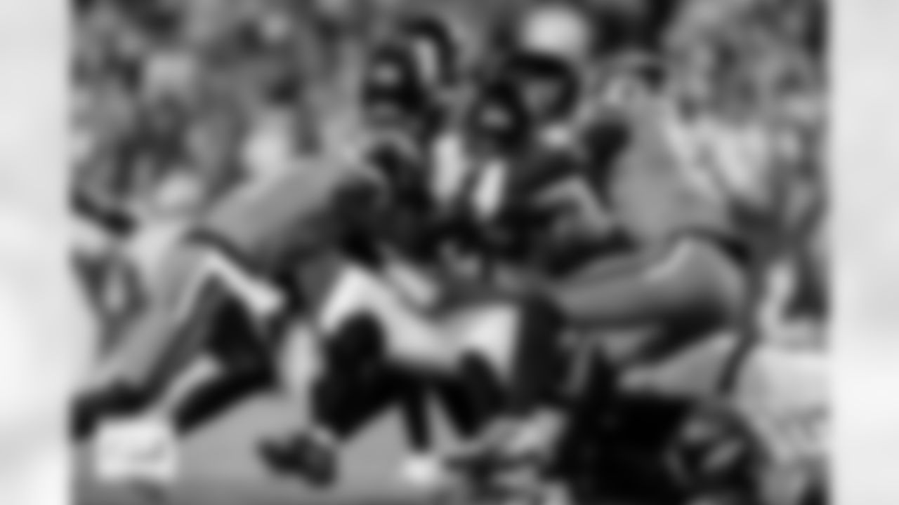 Denver Broncos cornerback Riley Moss (21), linebacker Que Robinson (51) and others tackle Jacksonville Jaguars running back Travis Etienne Jr. (1) during the Broncos' Week 16 game against the Jacksonville Jaguars at Empower Field at Mile High in Denver, Colorado on December 21, 2025. Photo by Ben Swanson / Denver Broncos