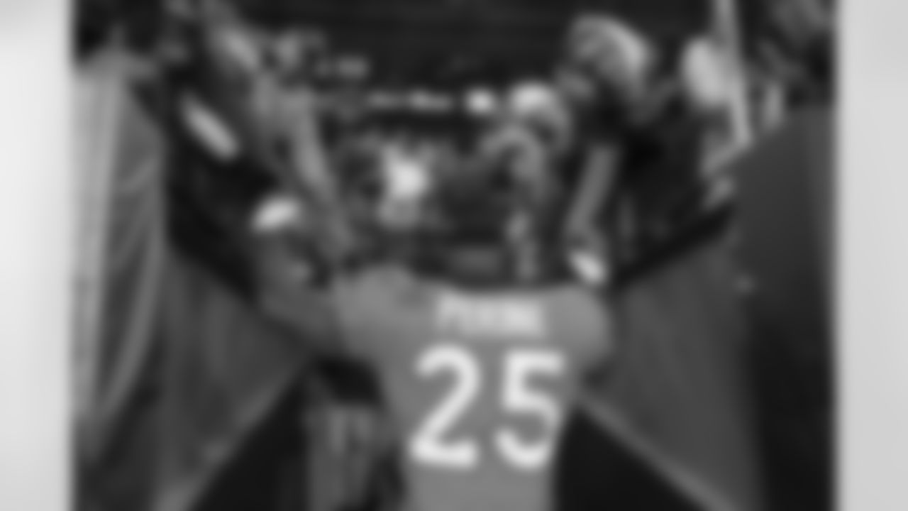 Denver Broncos running back Samaje Perine (25) high-fives fans as he goes into the locker room after the Broncos' Week 12 game against the Cleveland Browns at Empower Field at Mile High in Denver, Colorado on November 26, 2023. Photo by Rachel O'Driscoll / Denver Broncos