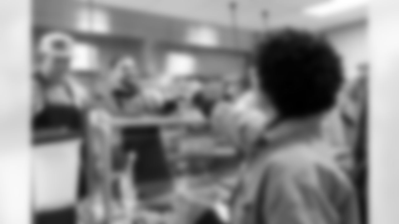 Garret Wallow hands over a plate of food during a visit to Urban Peak to feed the kids a Thanksgiving meal on Tuesday, November 25, 2025 at Urban Peak in Denver, Colorado.
Photo by Gabriel Christus / Denver Broncos