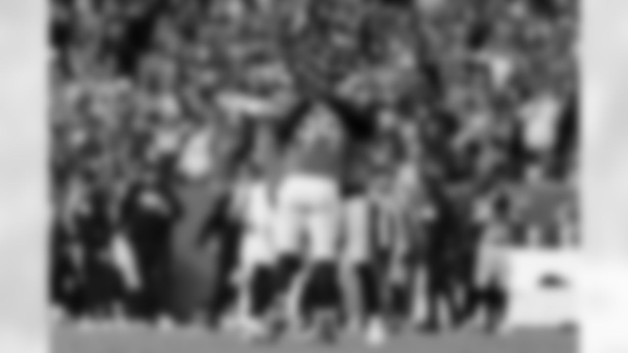 Denver Broncos defensive lineman Zach Allen (99) hugs linebacker Alex Singleton (49) and linebacker Jonathon Cooper (0) after a play during the Broncos' Week 15 game against the Green Bay Packers at Empower Field at Mile High in Denver, Colorado on December 14, 2025. Photo by Ben Swanson / Denver Broncos