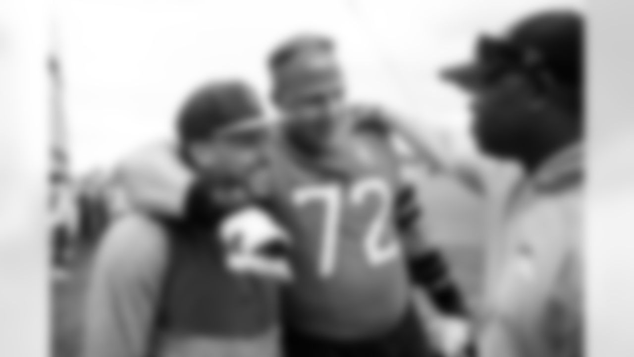 Phillip Lindsay greets Garett Bolles and Vance Joseph after an OTA practice at Broncos Park Powered by CommonSpirit in Englewood, Colorado on May 29, 2025. Photo by Ben Swanson / Denver Broncos