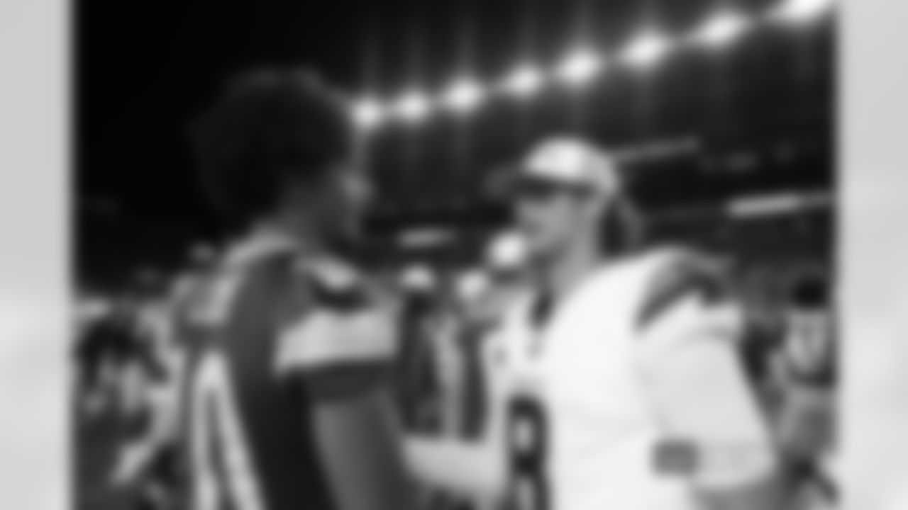 Jarrett Stidham #8 of the Denver Broncos talks with Jordan Love #10 of the Green Bay Packers after the Broncos' preseason Week 2 game against the Green Bay Packers at Empower Field at Mile High in Denver, Colorado on August 18, 2024. (Photo by Ben Swanson/Denver Broncos)