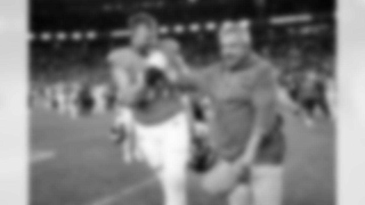 Denver Broncos offensive tackle Mike McGlinchey (69) and head coach Sean Payton celebrate after the Broncos' Week 11 game against the Kansas City Chiefs at Empower Field at Mile High in Denver, Colorado on November 16, 2025. Photo by Ben Swanson / Denver Broncos