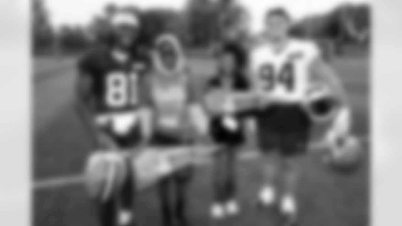 Wide receiver Michael Woods II (81), Stay in the Game! guests and Defensive tackle Mason Graham (94) during the first day of OTAs at CrossCountry Mortgage Campus on May 27, 2025.