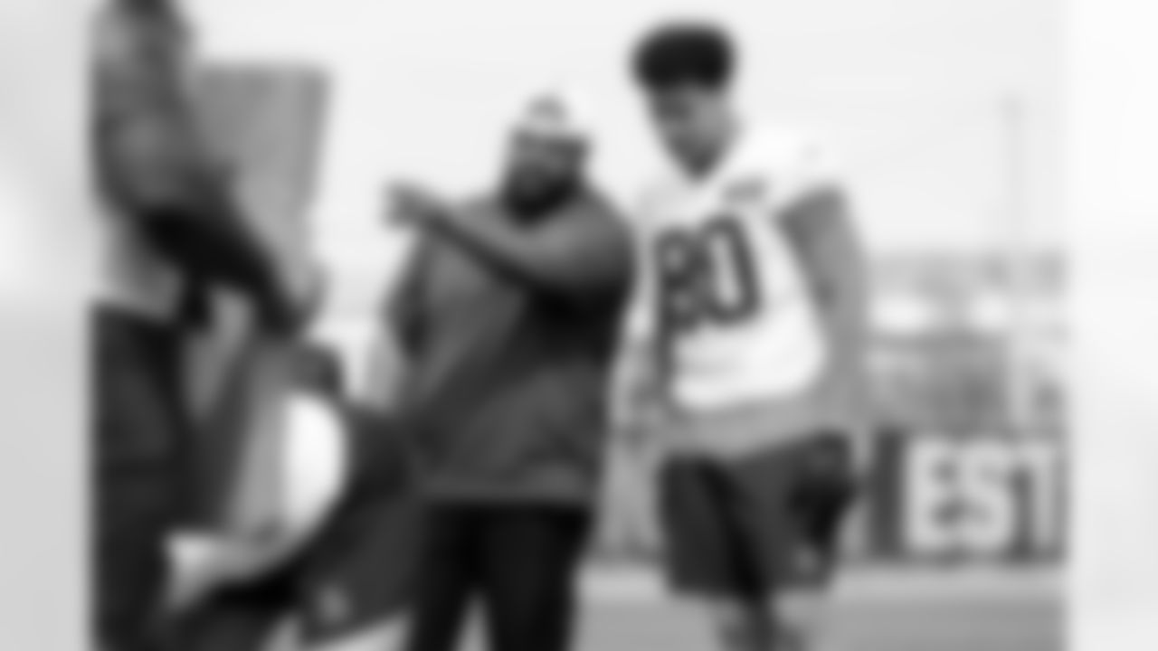Assistant Defensive Line Coach Adam Morris and Defensive end Joe Tryon-Shoyinka (90) during fieldwork in Phase II of the offseason at CrossCountry Mortgage Campus on May 12, 2025.