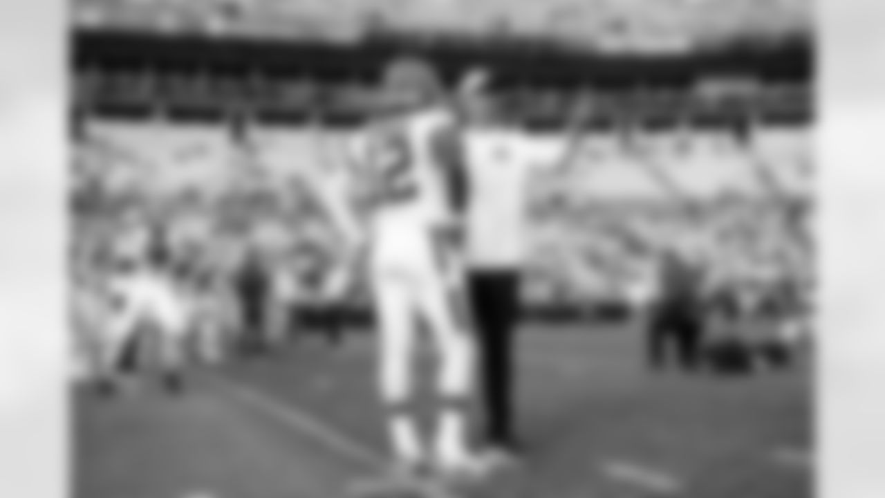 Quarterback Shedeur Sanders (12) and Offensive Coordinator Tommy Rees before a preseason NFL football game between the Cleveland Browns and Carolina Panthers on August 8, 2025 at Bank of America Stadium. The Browns won 30-10.