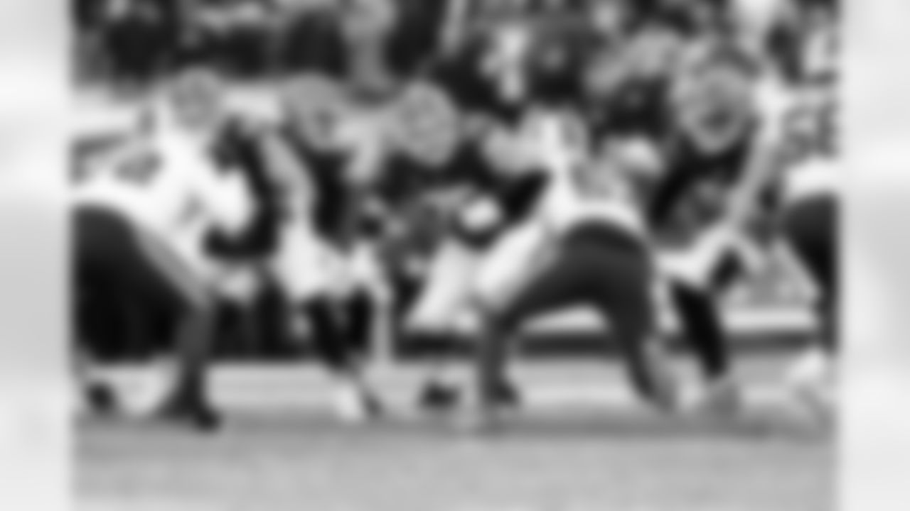 Quarterback Shedeur Sanders (12) and Offensive guard Joel Bitonio (75) during a NFL football game between the Buffalo Bills and Cleveland Browns on December 21, 2025 at Huntington Bank Field.