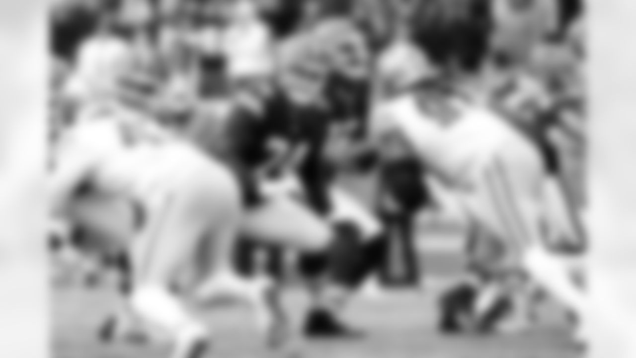 Offensive guard Teven Jenkins (74) and Quarterback Shedeur Sanders (12) during a NFL football game between the San Francisco 49ers and Cleveland Browns on November 30, 2025 at Huntington Bank Field.