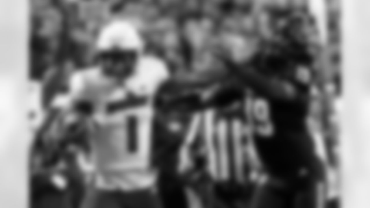 Louisville's Jamari Thrash (1) stiff-arms North Carolina State's Bishop Fitzgerald (19) during the second half of an NCAA college football game in Raleigh, N.C., Friday, Sept. 29, 2023. (AP Photo/Karl B DeBlaker)