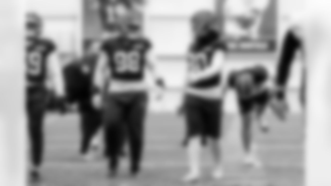 Defensive lineman Adin Huntington (98) and Linebacker Devin Bush (30) during practice at CrossCountry Mortgage Campus on December 31, 2025.