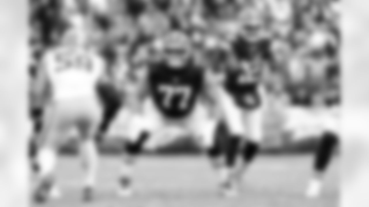 Offensive guard Wyatt Teller (77) and Quarterback Shedeur Sanders (12) during a NFL football game between the San Francisco 49ers and Cleveland Browns on November 30, 2025 at Huntington Bank Field.