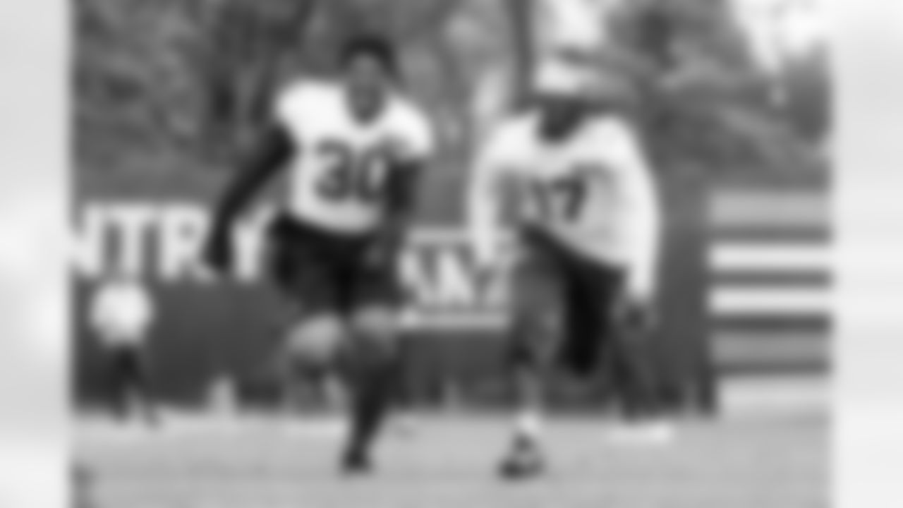 Linebacker Devin Bush (30) and Linebacker Jerome Baker (17) during fieldwork in Phase II of the offseason at CrossCountry Mortgage Campus on May 6, 2025.
