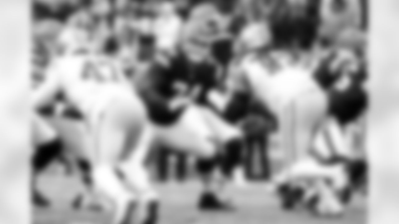 Offensive guard Teven Jenkins (74) and Quarterback Shedeur Sanders (12) during a NFL football game between the San Francisco 49ers and Cleveland Browns on November 30, 2025 at Huntington Bank Field.