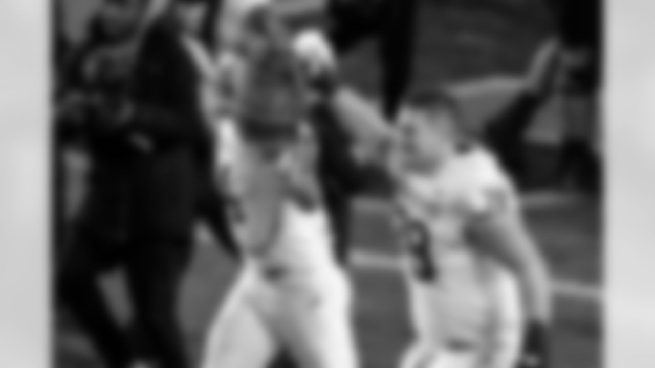 Indiana linebacker Aiden Fisher (4) and offensive lineman Pat Coogan (78) celebrate with the Old Oaken Bucket trophy after an NCAA college football game against Purdue, Friday, Nov. 28, 2025, in West Lafayette, Ind. (AP Photo/Doug McSchooler)