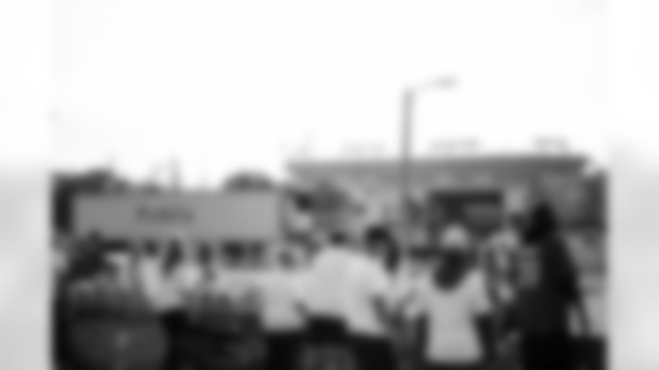 TAMPA, FL - November 25, 2025 - Volunteers during Turkey Time with the O-Line. Photo By Kyle Zedaker/Tampa Bay Buccaneers