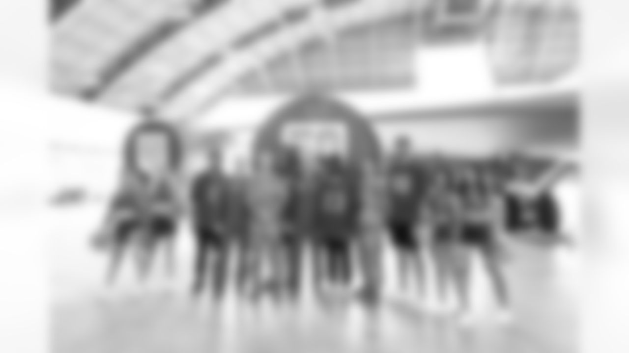 TAMPA, FL - December 02, 2025 - Tampa Bay Buccaneers Cheerleaders, Guard Luke Goedeke #67, Inside Linebacker SirVocea Dennis #8, Safety Tykee Smith #23, and Outside Linebacker Anthony Nelson #98 of the Tampa Bay Buccaneers during a visit to MacDill Air Force Base. Photo By Kyle Zedaker/Tampa Bay Buccaneers