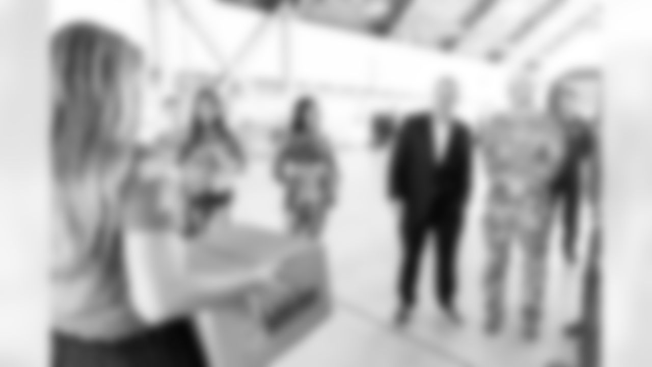 TAMPA, FL - December 02, 2025 - Brian Ford, the Buccaneers Salute to Service Nominee, receives a gift during a visit to MacDill Air Force Base. Photo By Kyle Zedaker/Tampa Bay Buccaneers