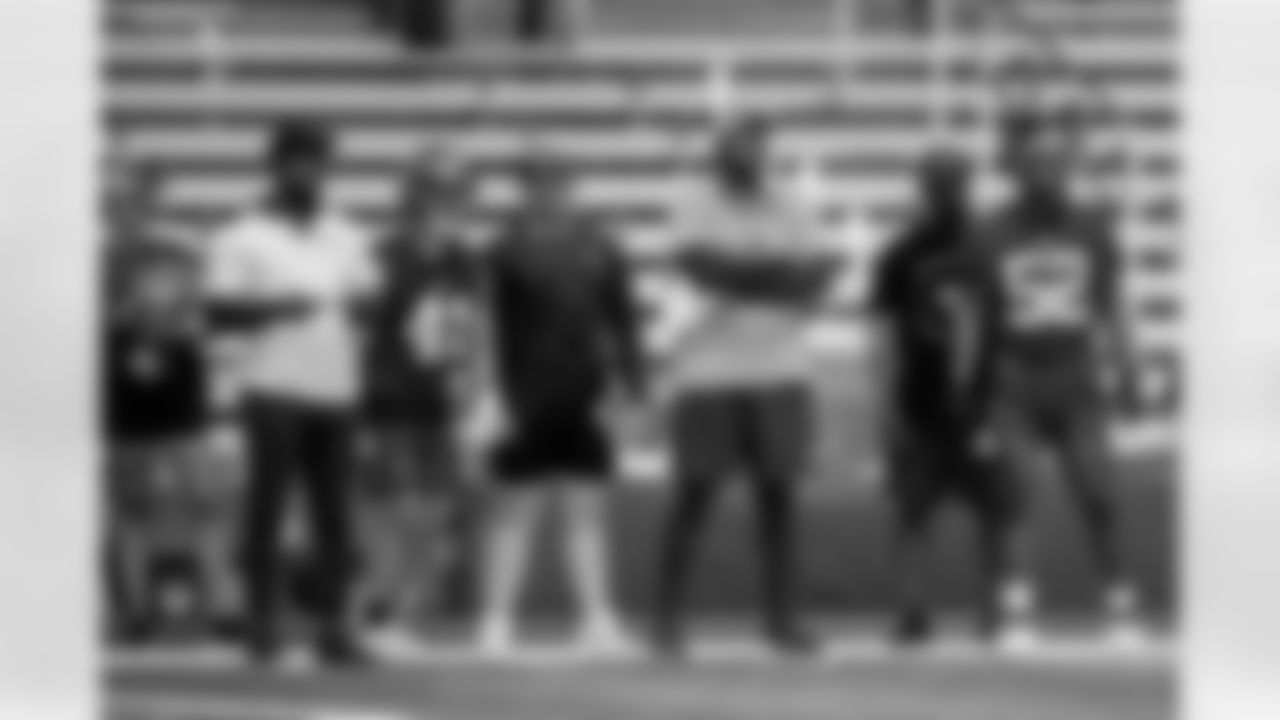 TAMPA, FL - May 10, 2025 - Director of Performance Nutrition Jessica Pastuf, Maurice Fleming, Cornerbacks Coach/Defensive Pass Game Coordinator for Eastern Illinois University, Linebacker Colin Ramos #41, Luke Mueller, Defensive Coordinator for Bolingbrook High School, Inside Linebackers Coach Mike Caldwell, Juan Thrasher, Defensive Coordinator/Safeties Coach for Flower Mound High School, and Linebacker Nick Jackson #52 of the Tampa Bay Buccaneers during rookie minicamp practice. Photo By Kyle Zedaker/Tampa Bay Buccaneers