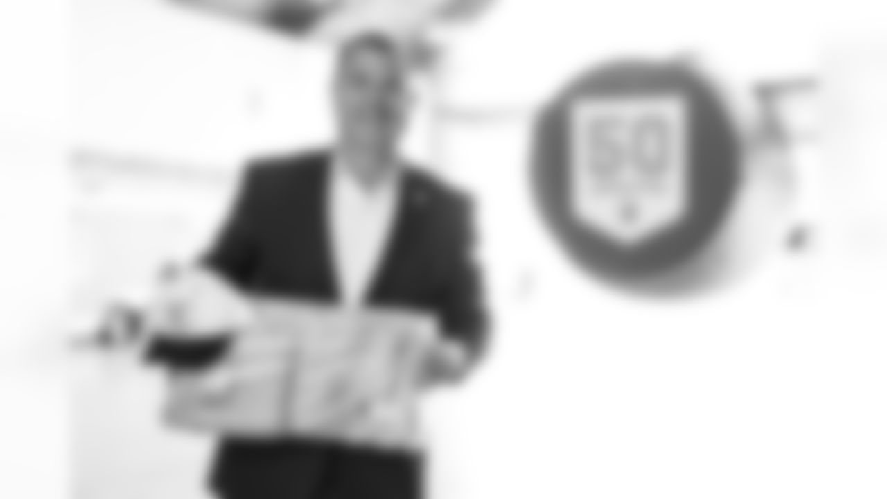 TAMPA, FL - December 02, 2025 - Brian Ford, the Buccaneers Salute to Service Nominee, receives a gift during a visit to MacDill Air Force Base. Photo By Kyle Zedaker/Tampa Bay Buccaneers