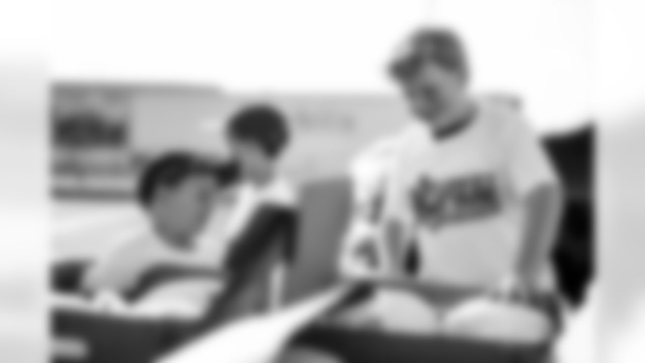 TAMPA, FL - November 25, 2025 - Volunteers during Turkey Time with the O-Line. Photo By Kyle Zedaker/Tampa Bay Buccaneers